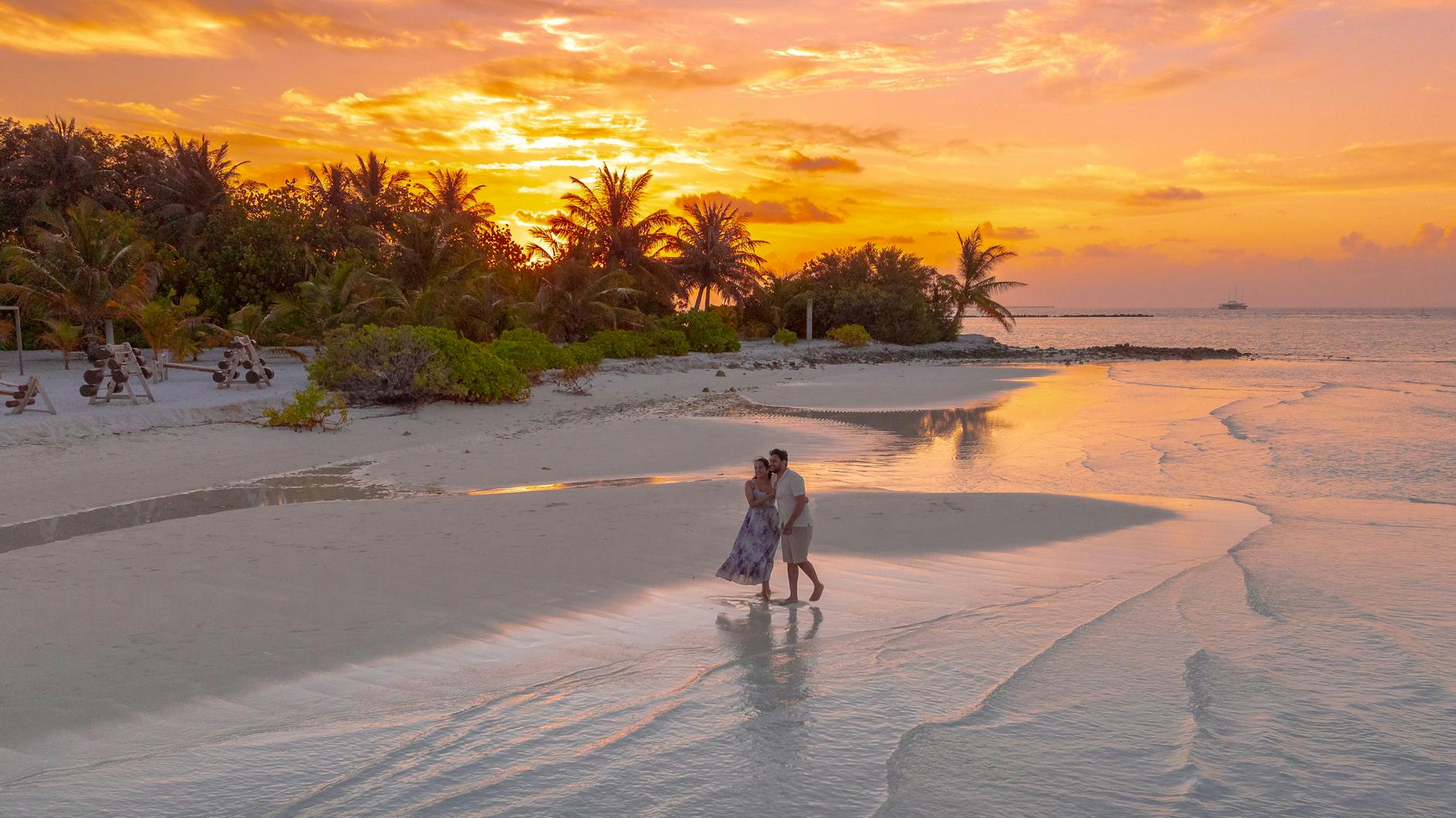 romantic sunset walk on a maldivian beach